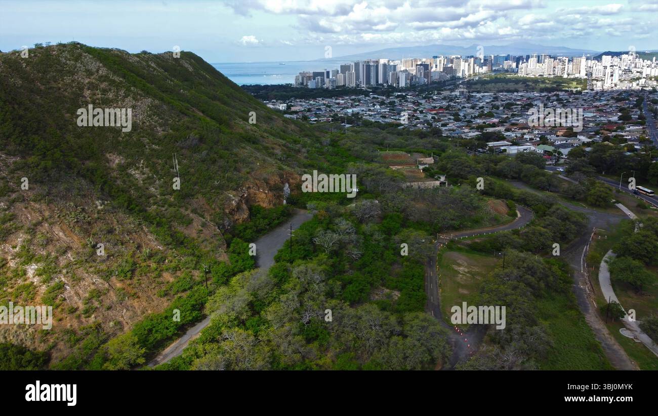 Aerial view of Diamond Head Crater and Honolulu skyline, lush green ...