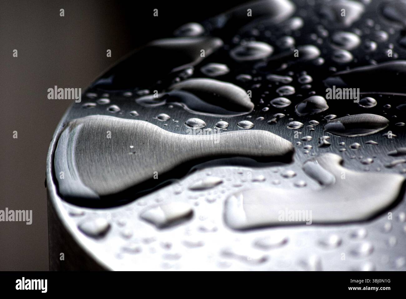Macro close-up of water droplets on brushed metal surface Stock Photo ...