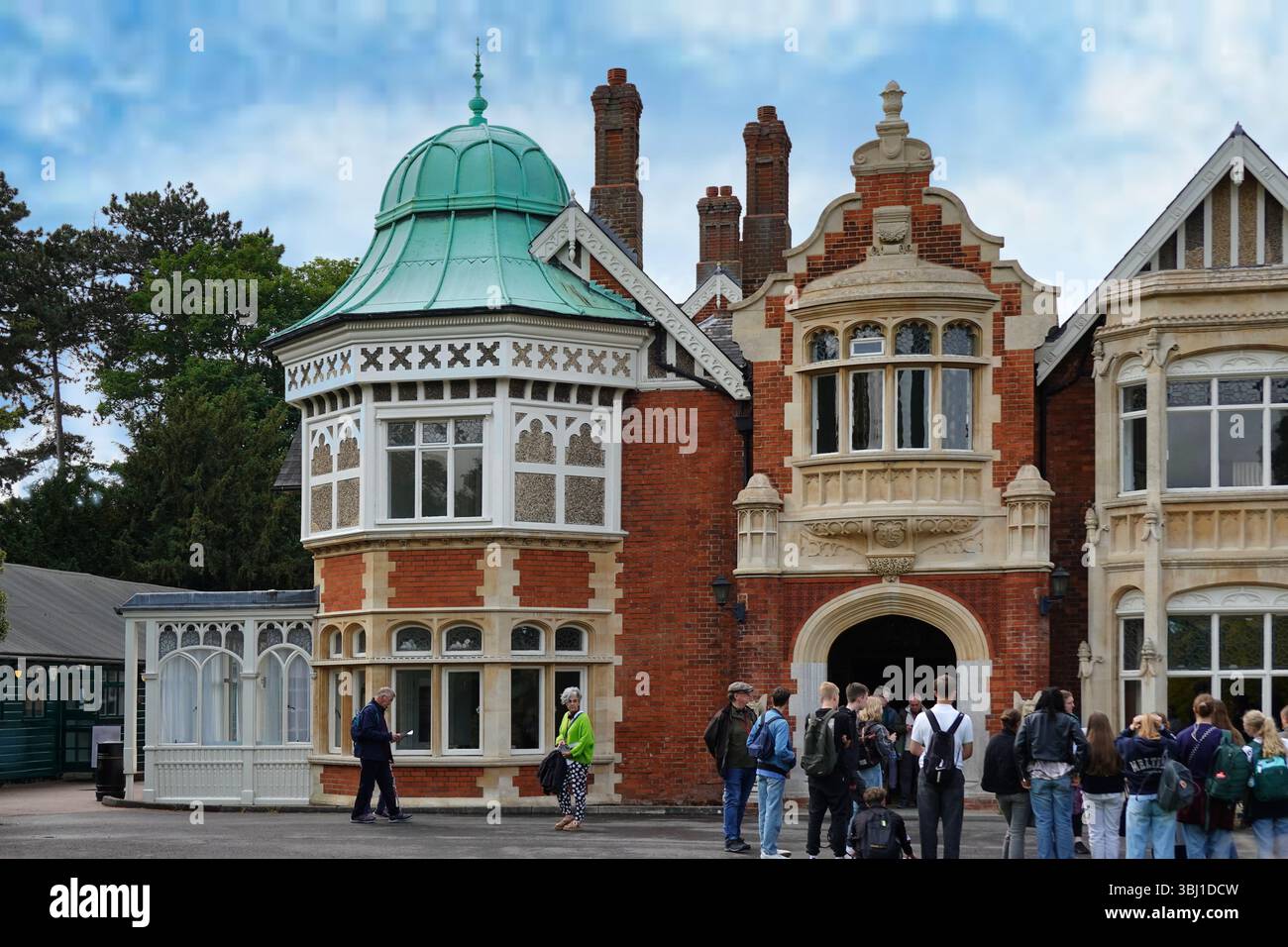 A group of students outside The Mansion a Victorian building at Bletchley Park museum and heritage attraction near Milton Keynes, England, UK Stock Photo
