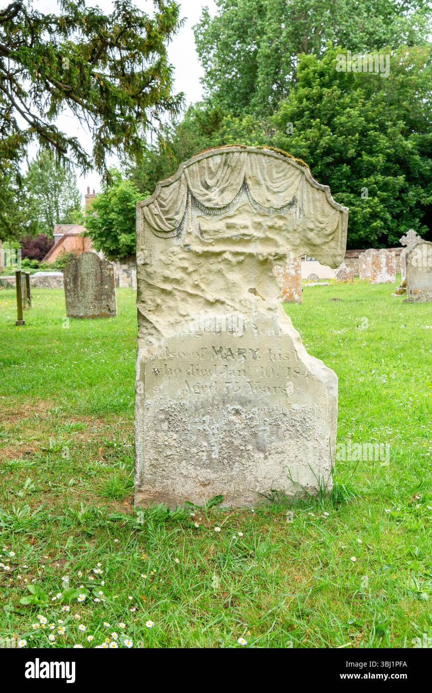 Badly eroded grave stone Stock Photo - Alamy