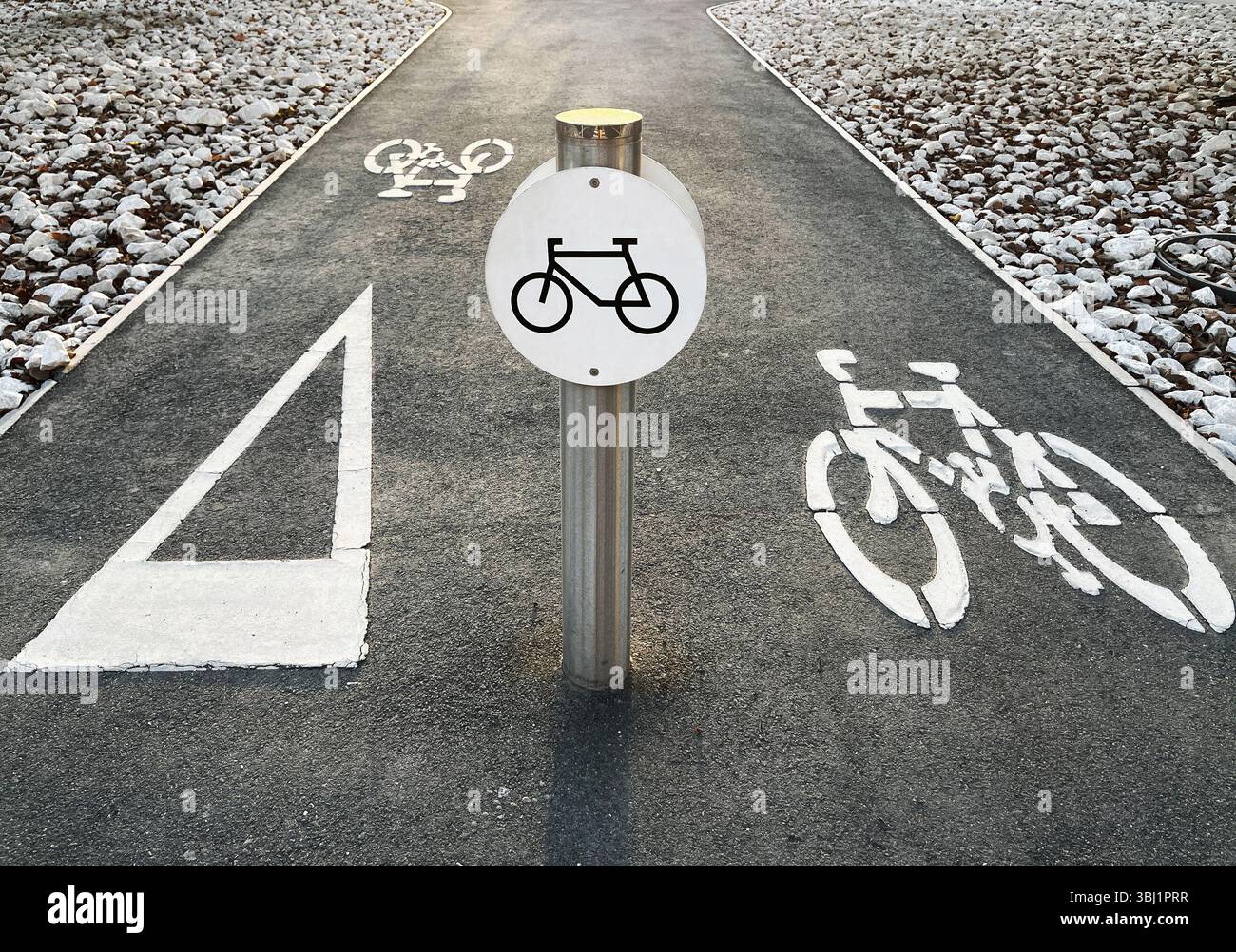 Bicycle lane sign on an asphalt road with bike symbols and white ...