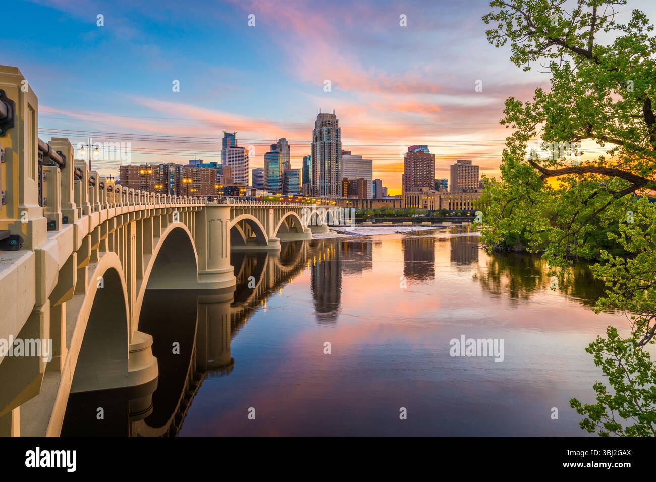Minneapolis, Minnesota, USA downtown skyline on the Mississippi River with the Third Avenue Bridge at twilight. Stock Photo