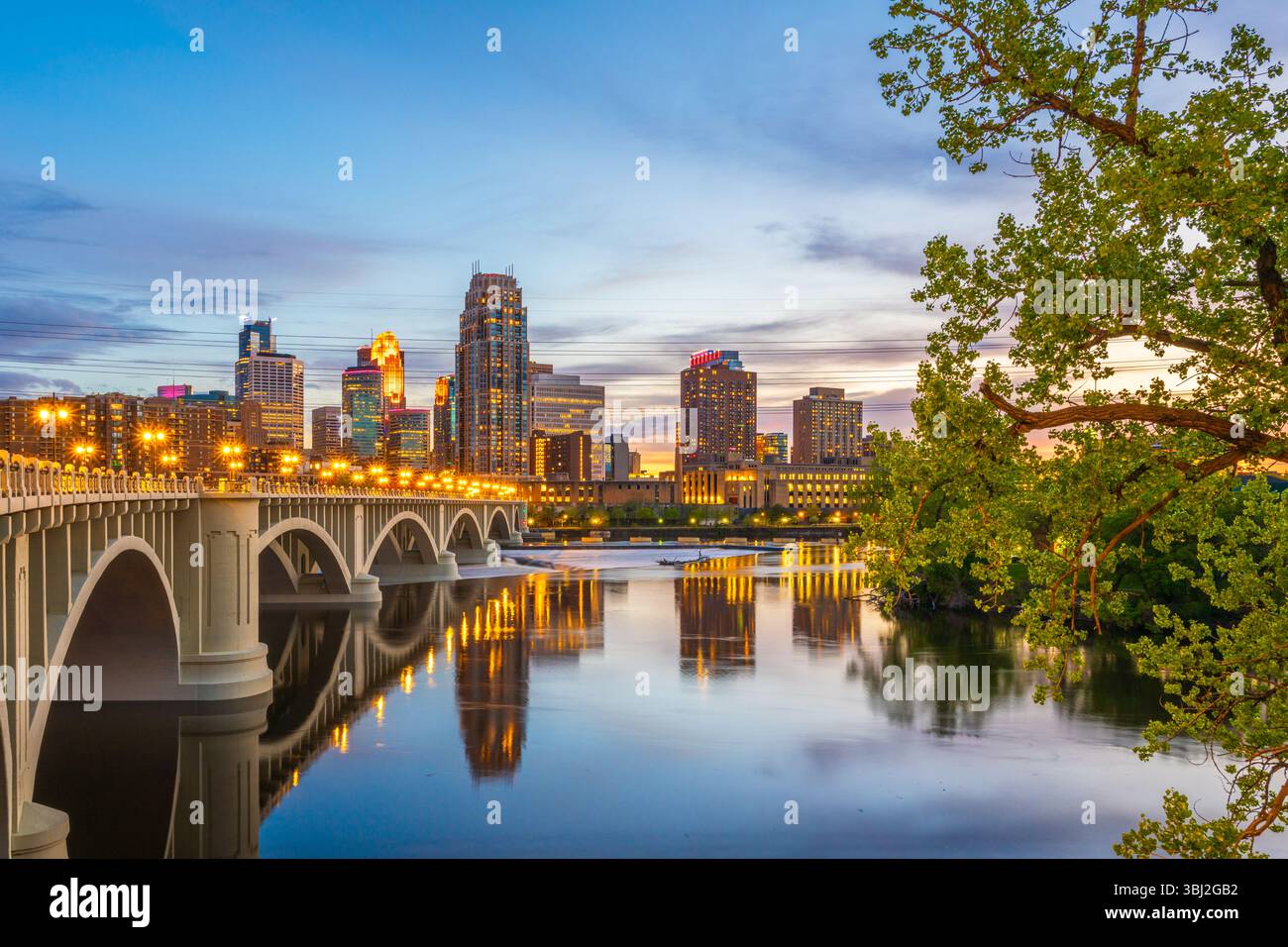 Minneapolis, Minnesota, USA downtown skyline on the Mississippi River with the Third Avenue Bridge at twilight. Stock Photo
