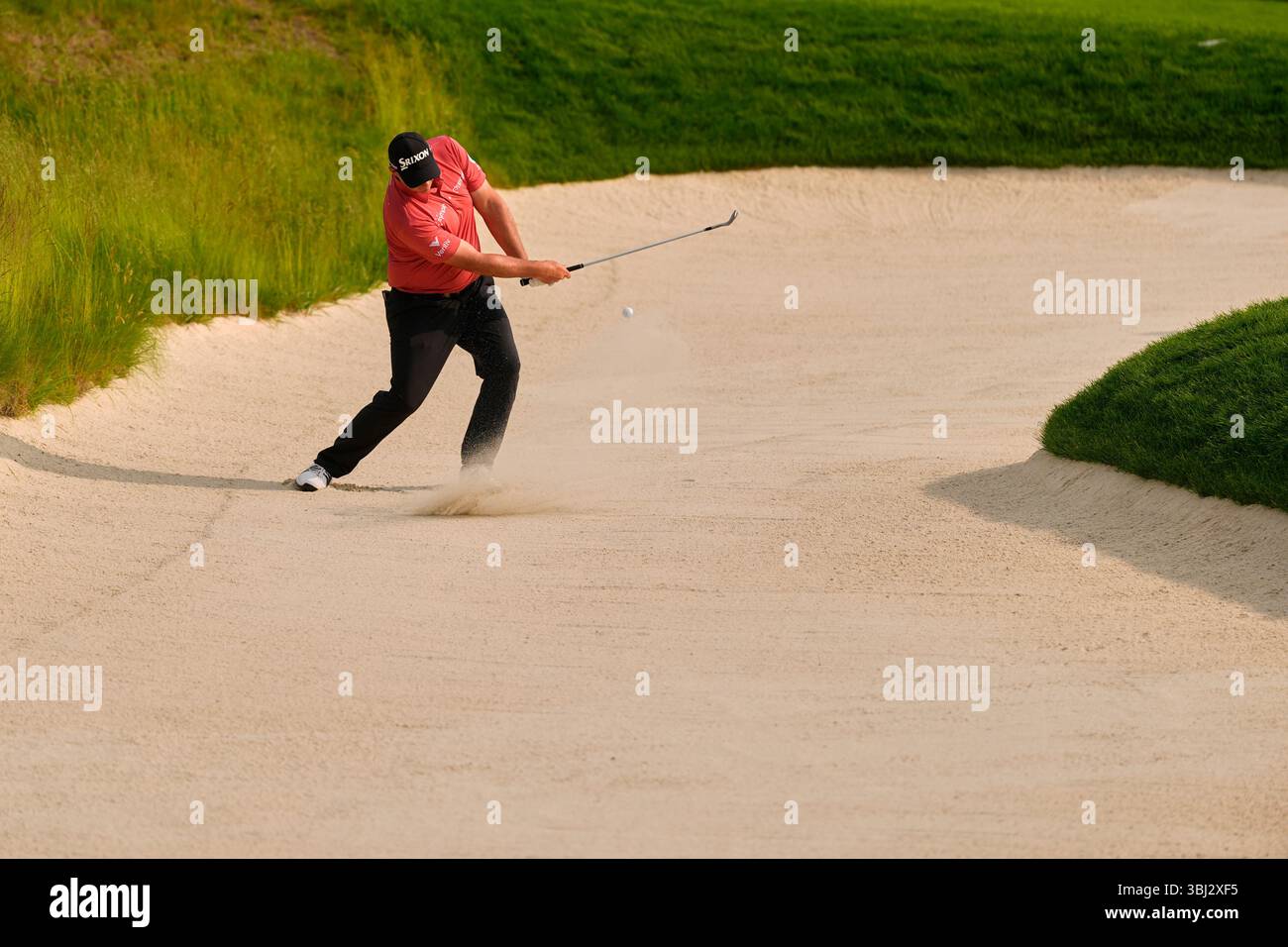 Sepp Straka, of Austria, hits from a bunker on the fifth hole during