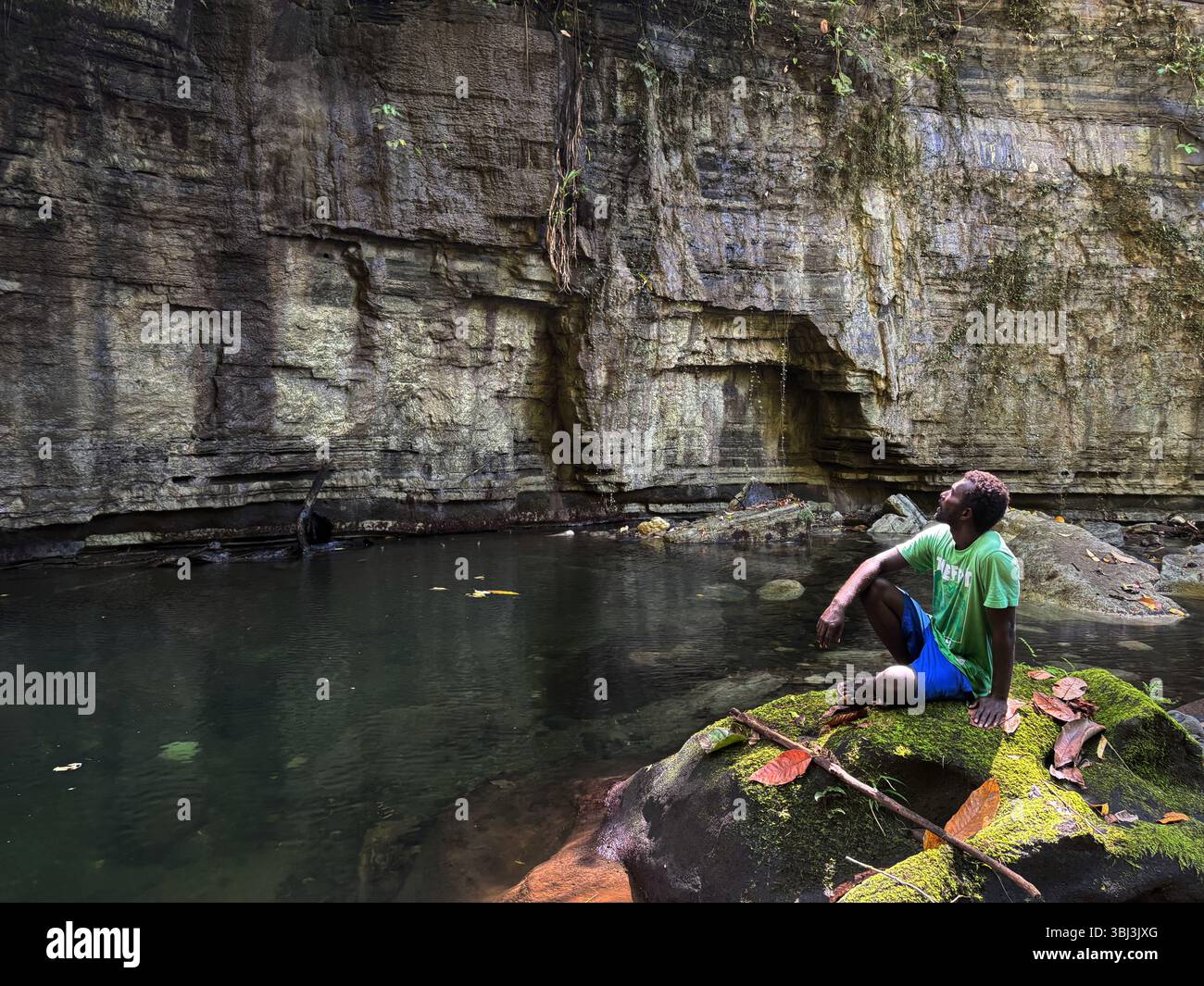 Local guide in freshwater slot canyon, Tetepare Island Marine Protected Area, Western Province, Solomon Islands. No MR - Smartphone Captured Stock Image