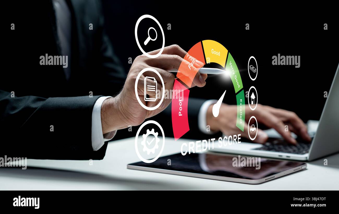 Businessman using a laptop while touching the icon of his credit score on the tablet screen. Technology innovation on a virtual screen. Concept of cre Stock Photo