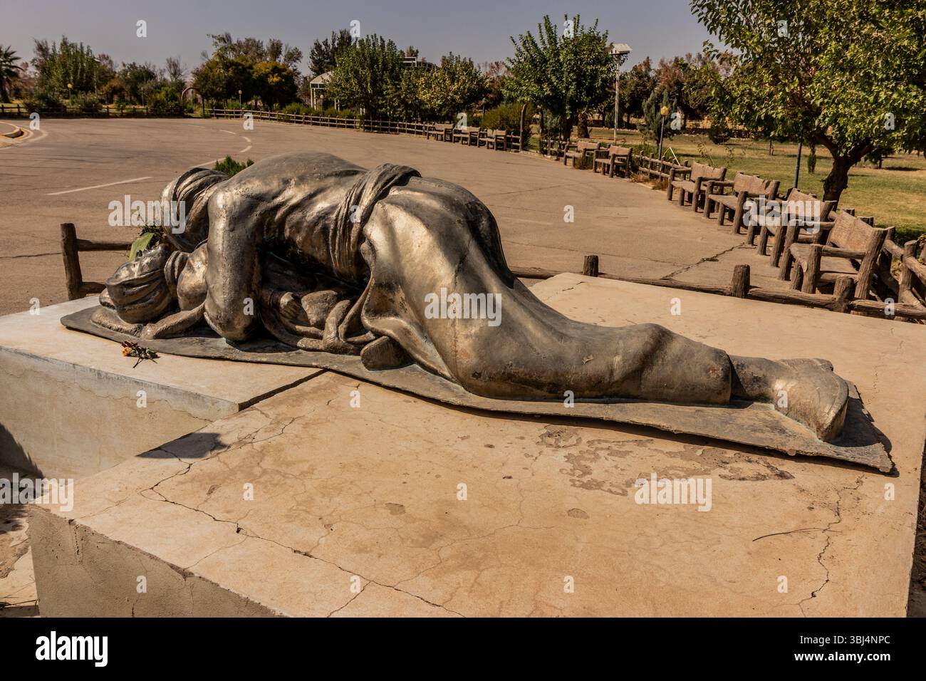 HALABJA, IRAQ - OCTOBER 6, 2022: Halabja Monument And Peace Museum grounds. Statue of a father protecting his child during the chemical attack in Hala Stock Photo