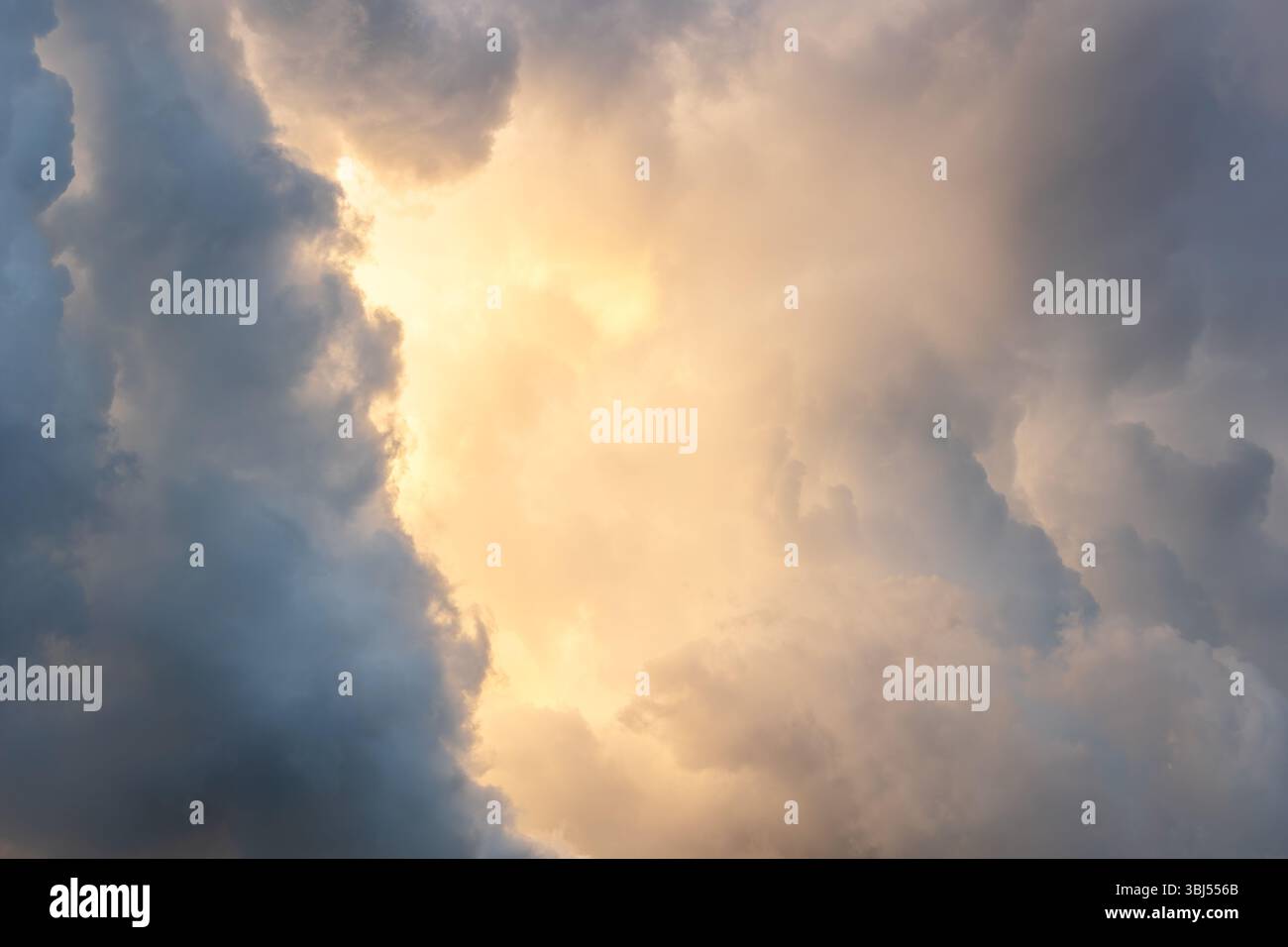 Sun lights is shining between storm clouds Stock Photo