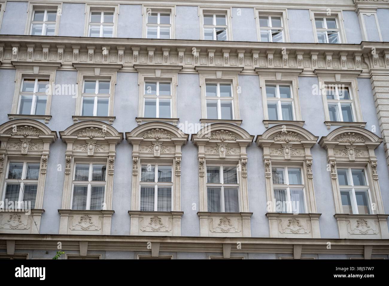 Historic European building facade with ornate windows and classical ...