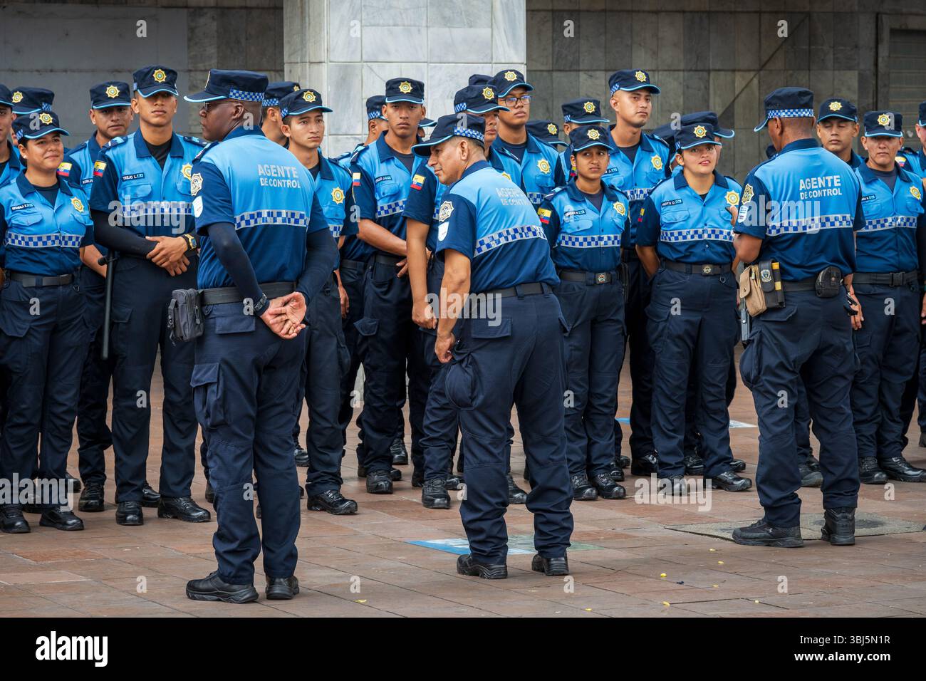 Guayaquil, Ecuador — January 21, 2025. Ecuadorian police officers in uniform stand at attention while they listen to orders from their commanding offi Stock Photo