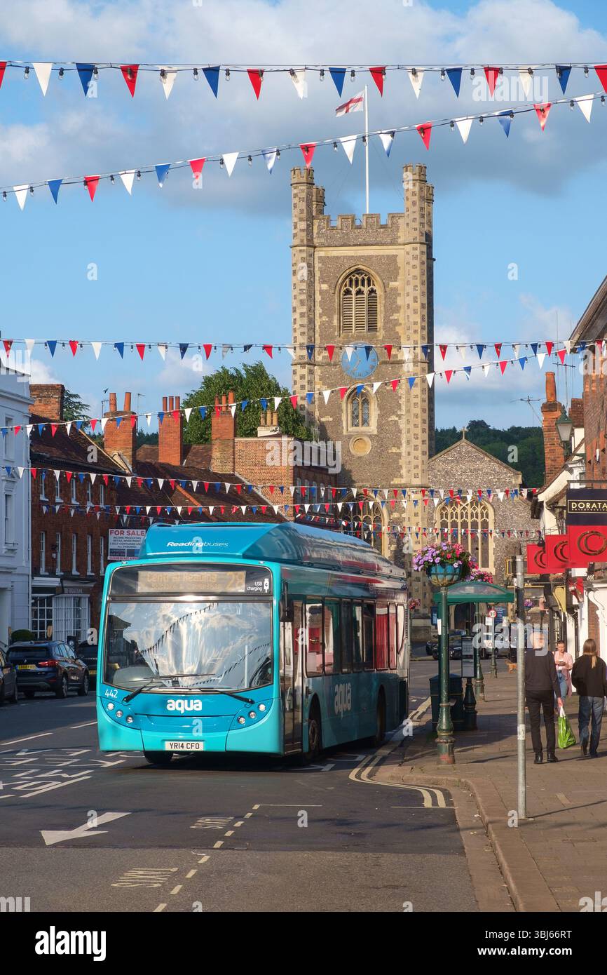 Reading Buses serrvice no 28 in Hart Street  Henley-on-Thames  and St. Mary's Church behind, with bunting and St. George's Flag Stock Photo