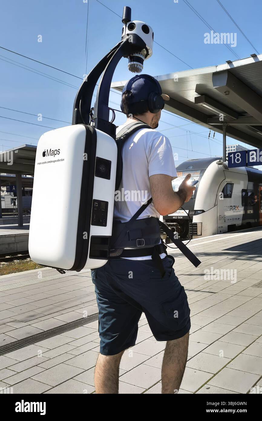 A man wears an electronic Apple Maps backpack with a camera system over ...