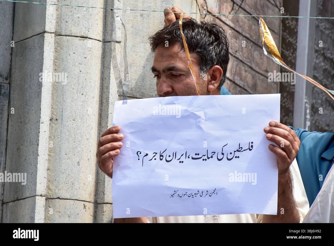 A Kashmiri Shiite Muslim holds a placard during a protest rally in ...