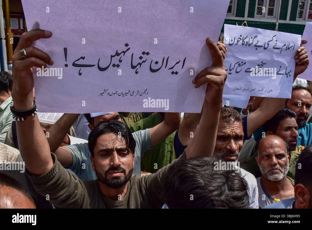 Kashmir, India. 13th June, 2025. A Kashmiri Shiite Muslim holds a ...