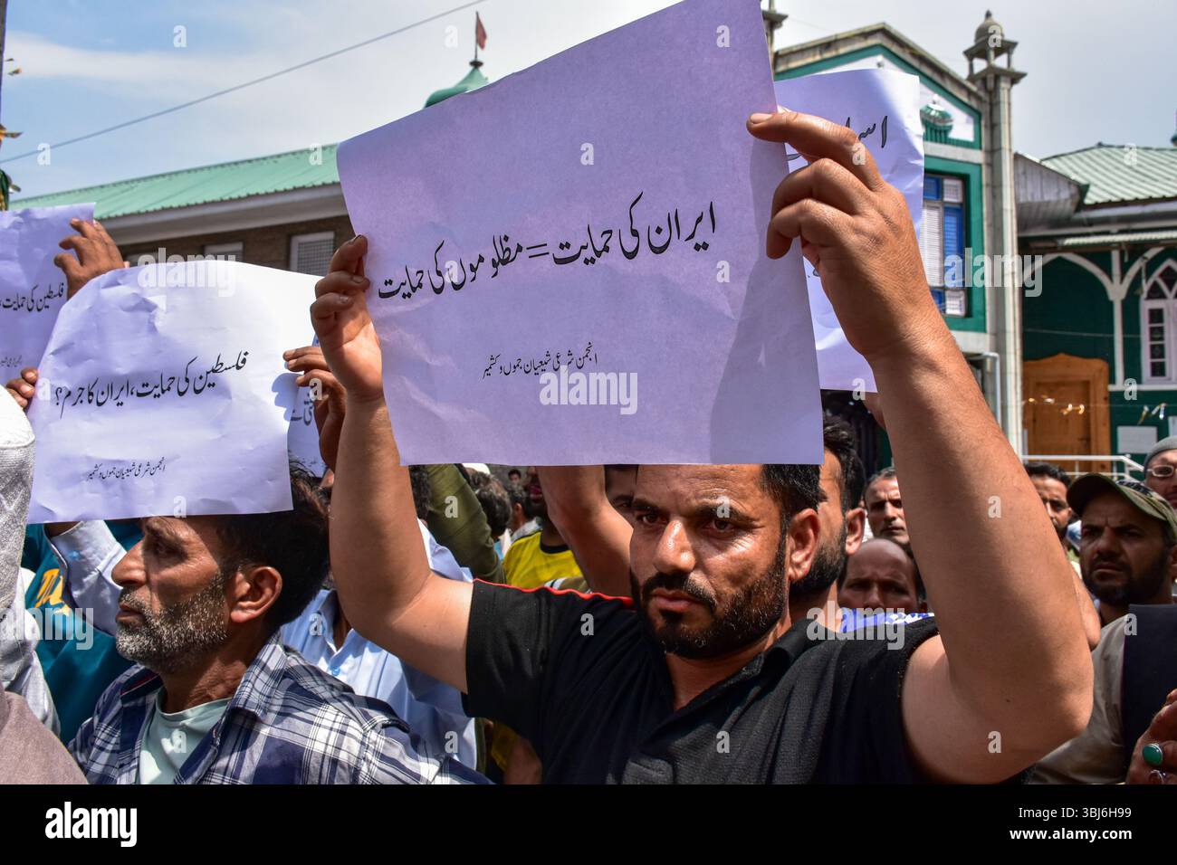 Kashmir, India. 13th June, 2025. Kashmiri Shiite Muslims hold placards ...