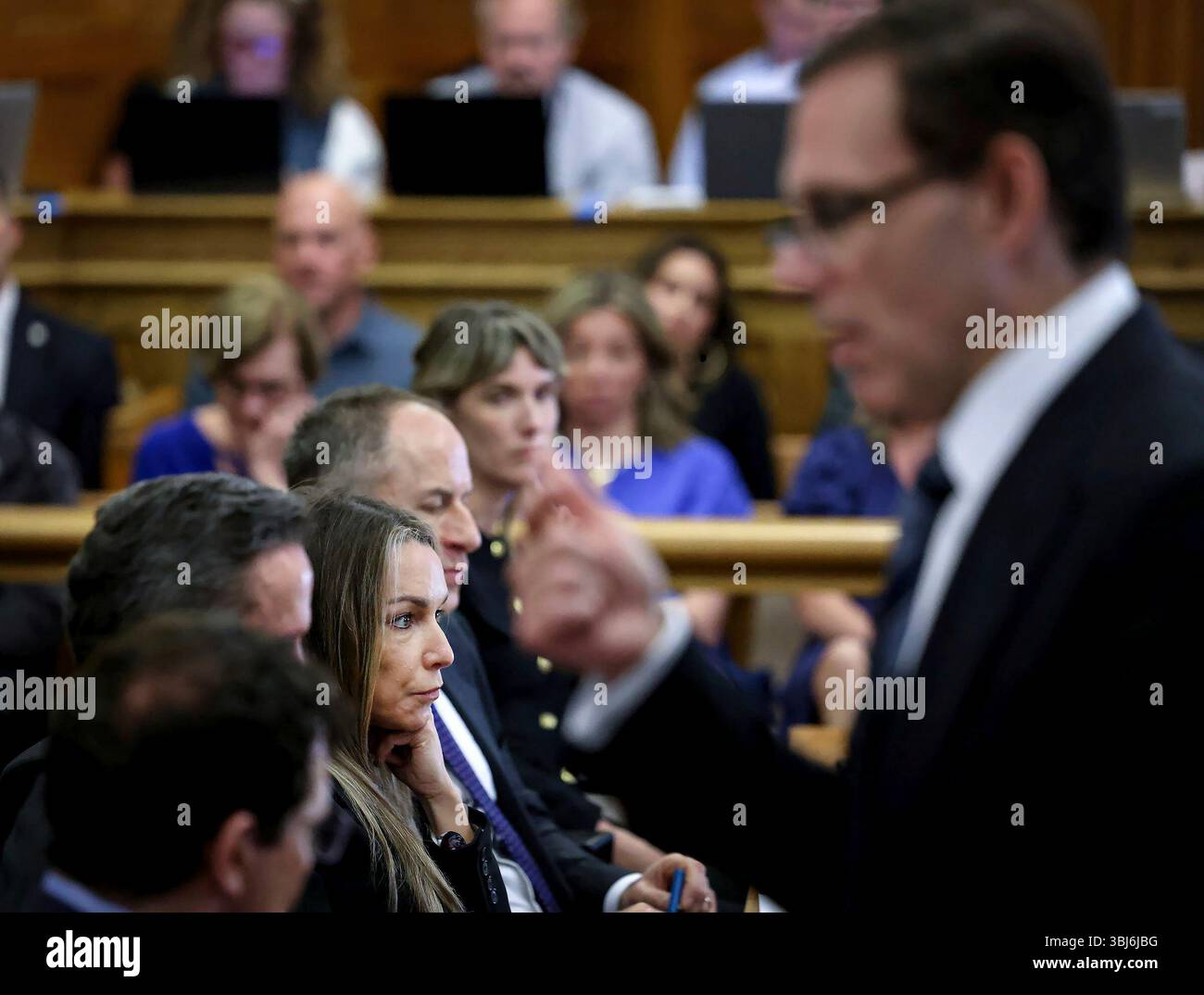 Defendant Karen Read, left, listens as prosecutor Hank Brennan speaks ...