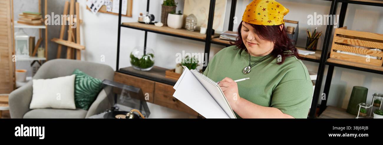 An elegant woman in a chic art studio passionately creates her designs while sketching ideas. Stock Photo