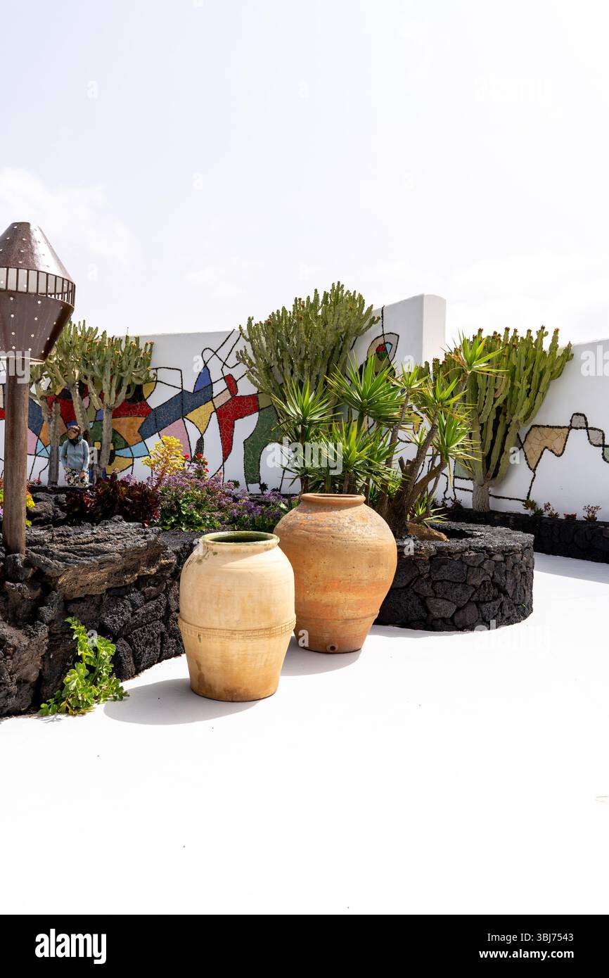 View of a garden with large pottery, and a colorful mural from the Cesar Manrique Foundation in Lanzarote. Stock Photo
