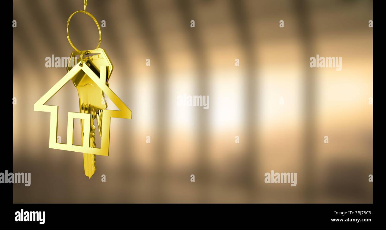Hanging house-shaped golden key ring holding two metallic keys in softly lit corridor, copy space Stock Photo