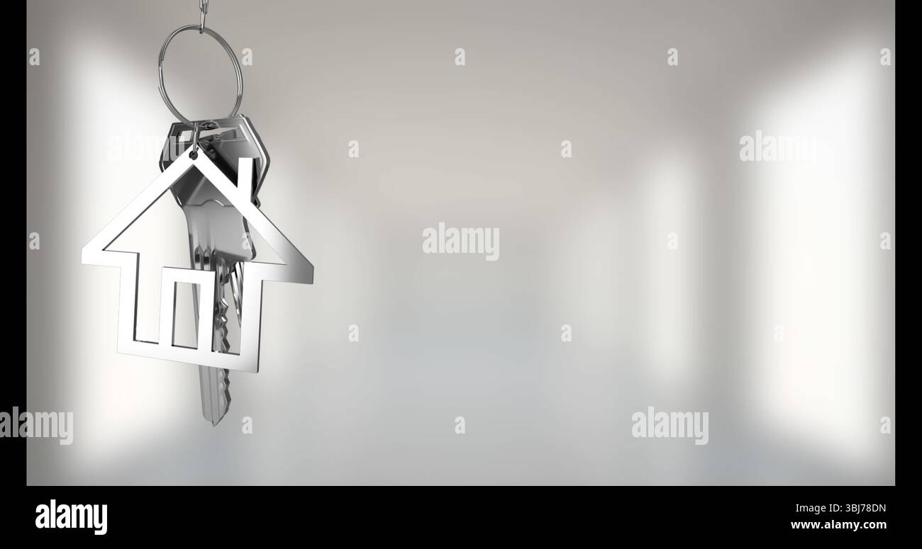 Hanging metallic house-shaped keychain holding silver keys at softly lit interior space, copy space Stock Photo
