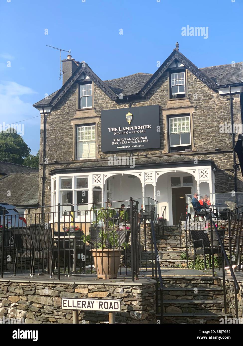 Lake Windermere shop shops town visit old historic history water pond outside people sit sat house houses pub beer eat food dinning rent hotel tourist - Smartphone Captured Stock Image