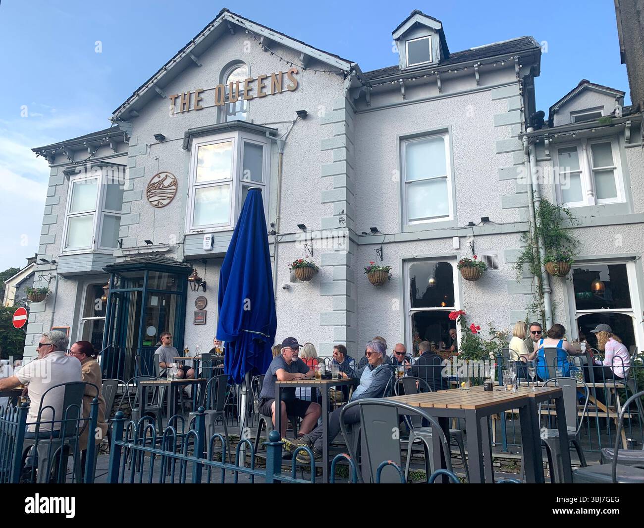 Lake Windermere shop shops town visit old historic history water pond outside people sit sat house houses pub beer eat food dinning rent hotel tourist - Smartphone Captured Stock Image
