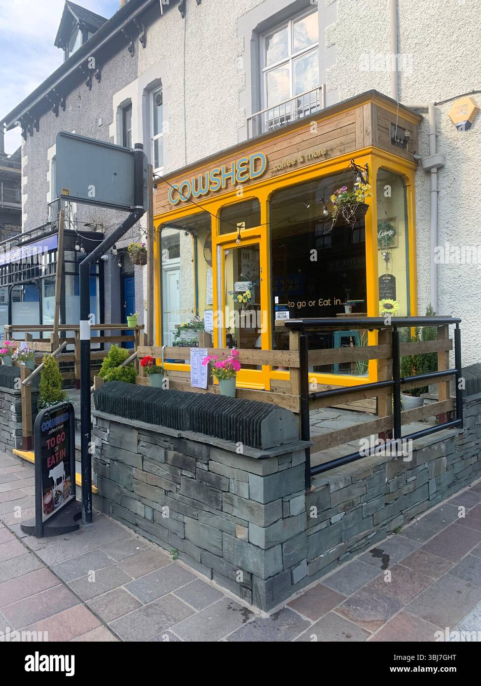 Lake Windermere shop shops town visit old historic history water pond outside people sit sat house houses pub beer eat food dinning rent hotel tourist - Smartphone Captured Stock Image