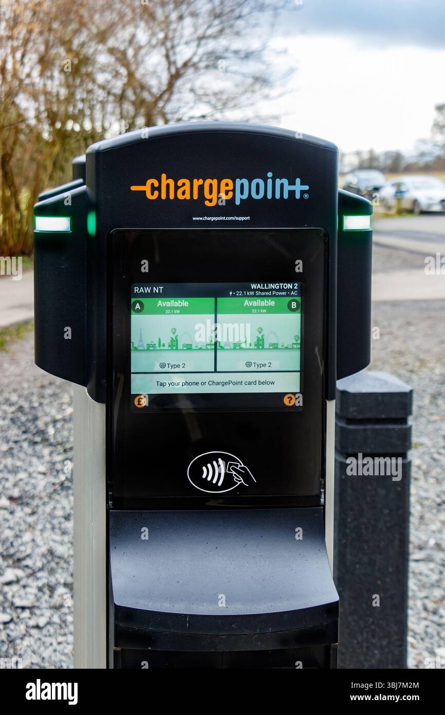 Electric vehicle charging station in a parking lot on a cloudy day ...