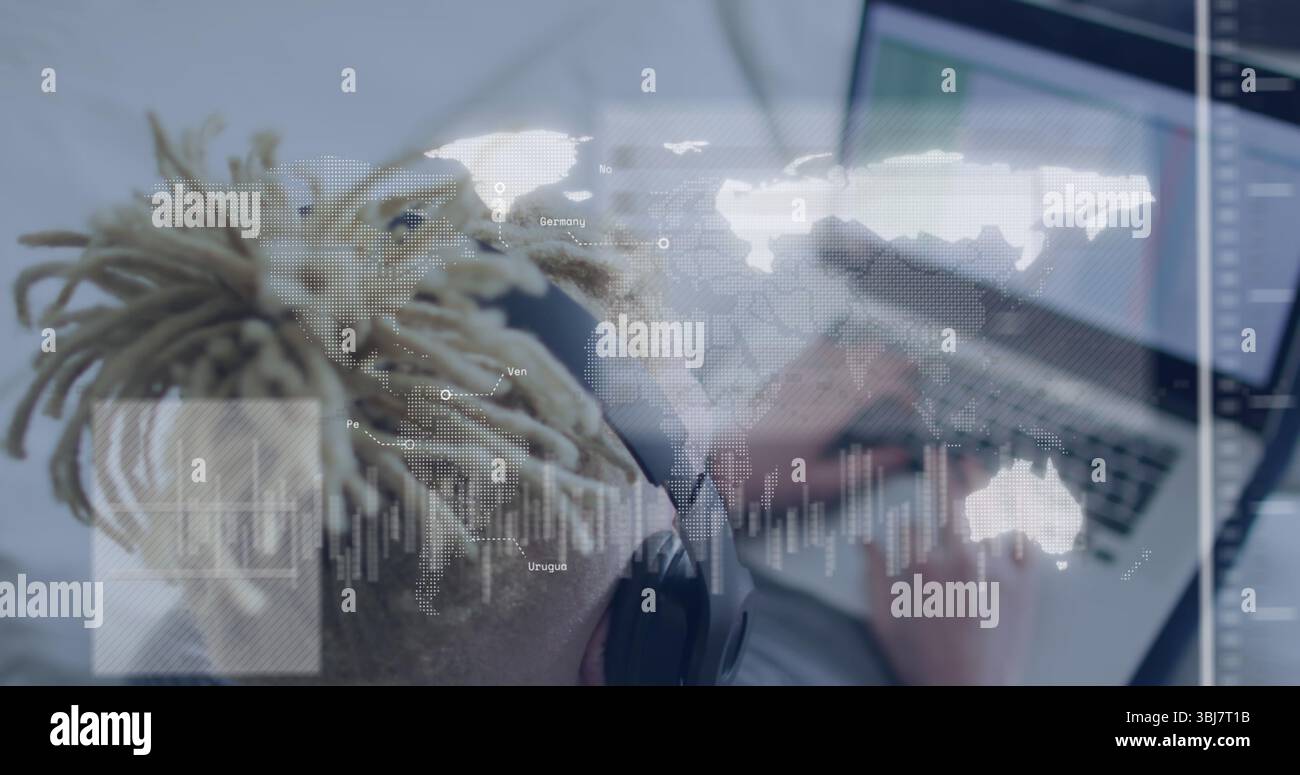 Typing man with dreadlocks wearing headset typing on laptop at home ...