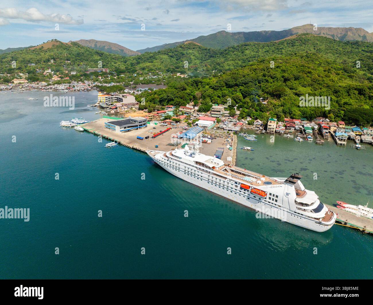 Coron Port with passenger ferry. Residential area in shoreline and ...
