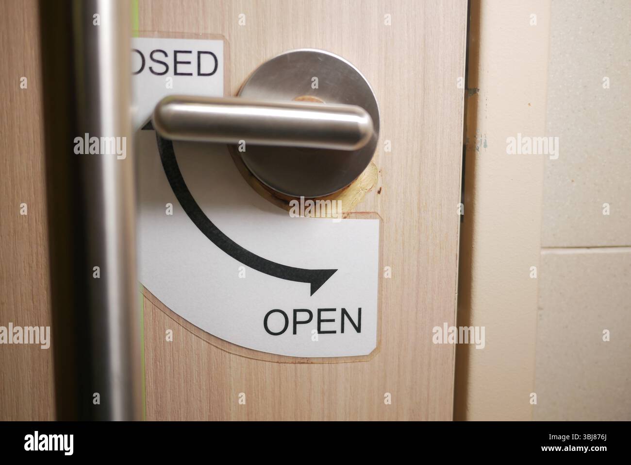 Door handle with open and closed signs at restroom entrance Stock Photo ...