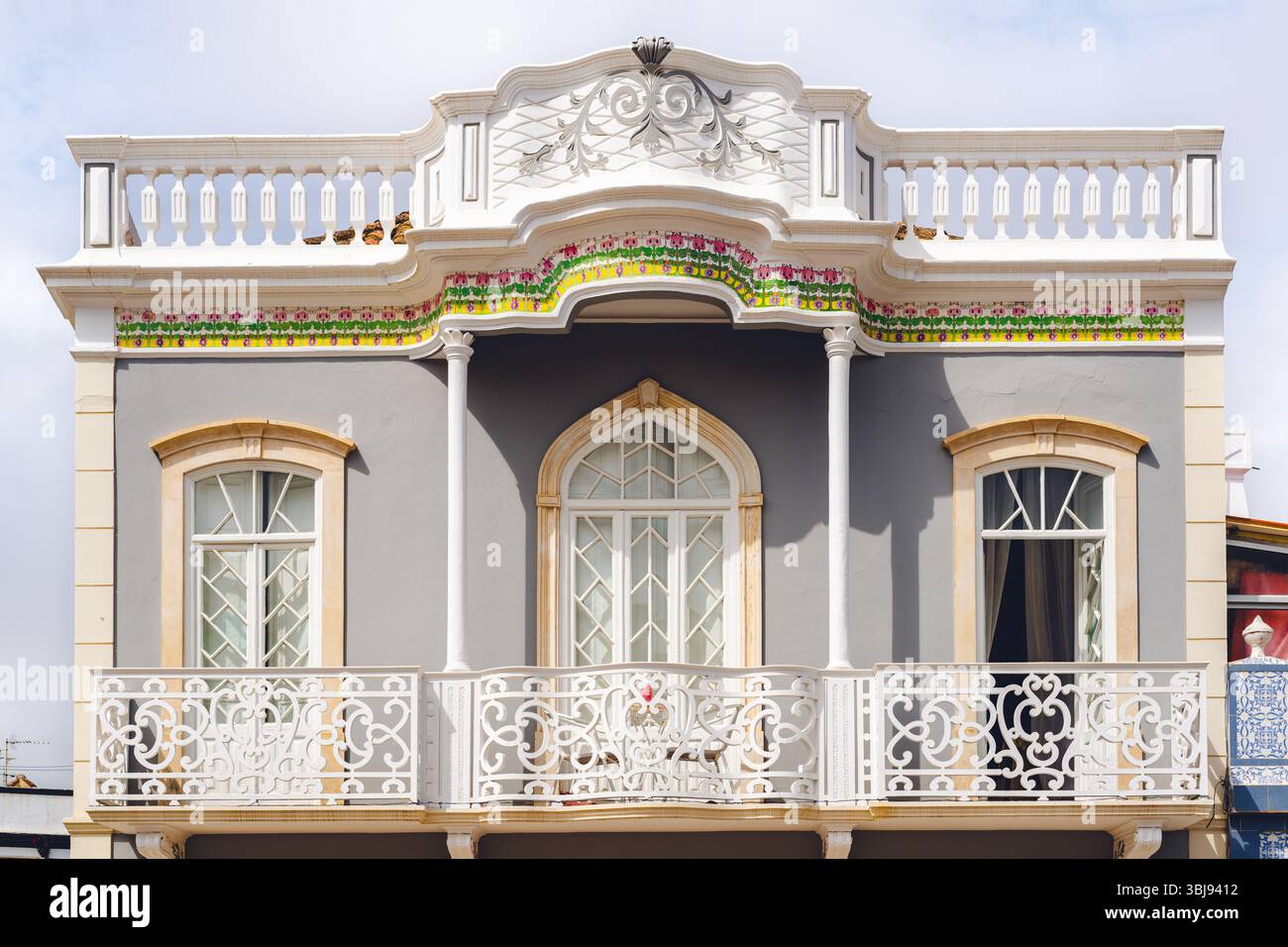Elegant architectural facade featuring arched windows, intricate white ...