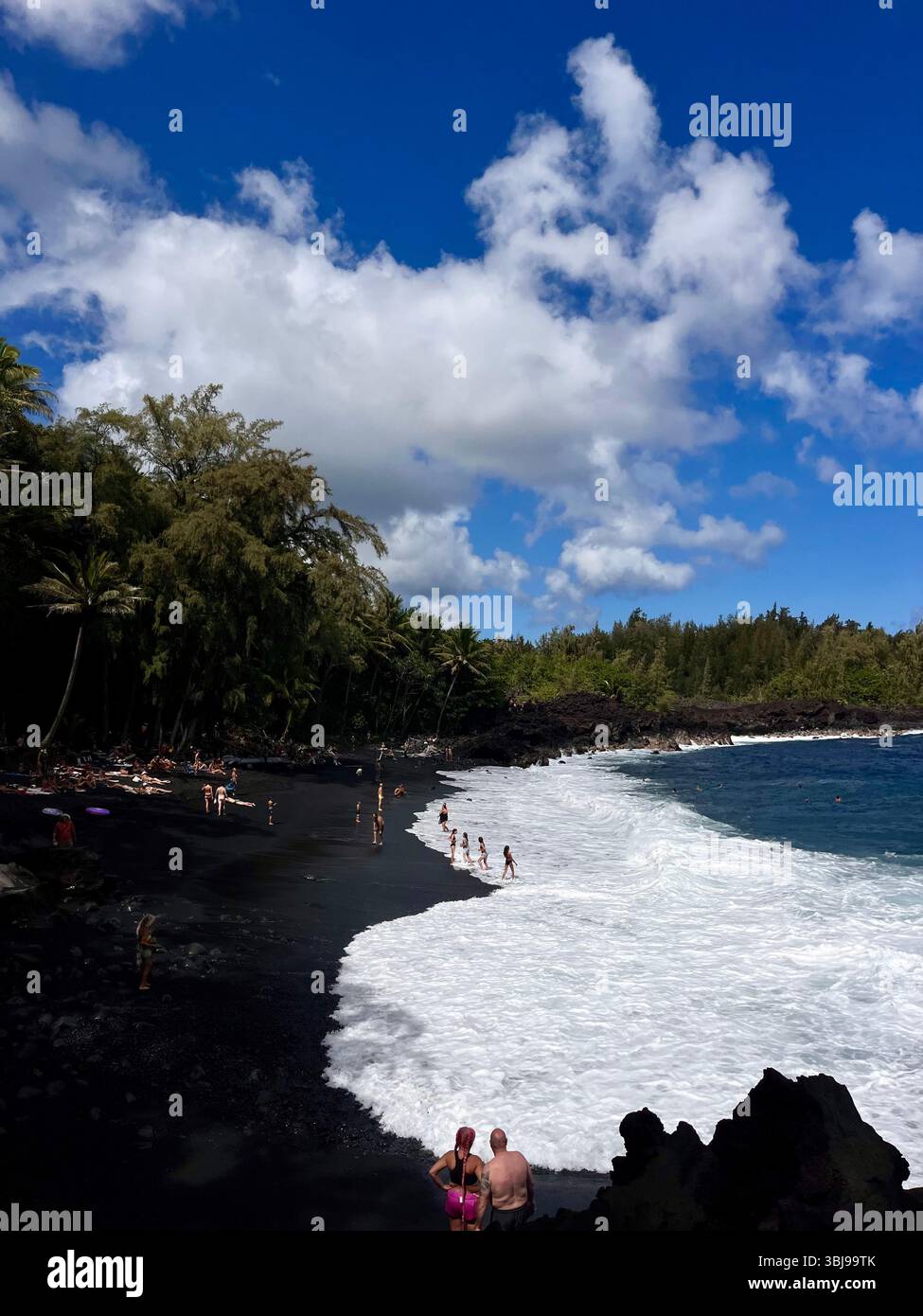 The beautiful and magical black sand beaches on the Big Island of Hawai'i, USA with volcanic black lava rock and crashing waves. - Smartphone Captured Stock Image