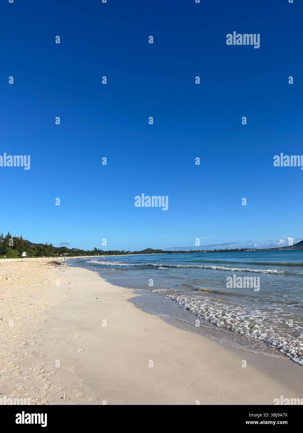 Waves washing ashire the sandy, picturesque and peaceful scenery of the beautiful Kailua Beach on the island of O'ahu, Hawai'i, USA. - Smartphone Captured Stock Image