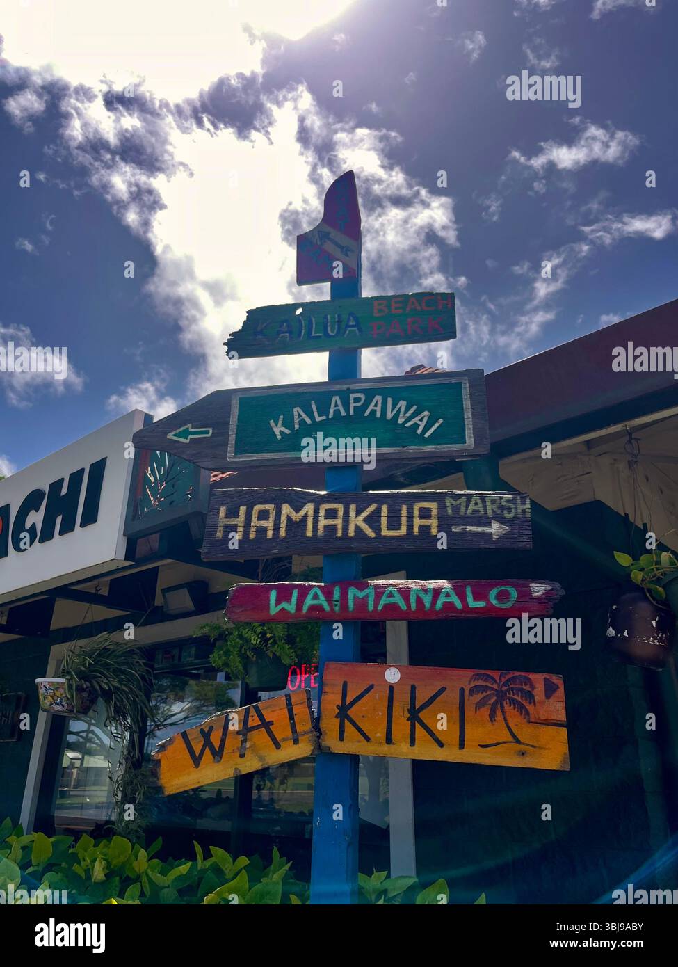 An aesthetic street sign on the North Shore of the island of O'ahu, Hawai'i, USA showing different areas of the magical island on a sun soaked day. - Smartphone Captured Stock Image