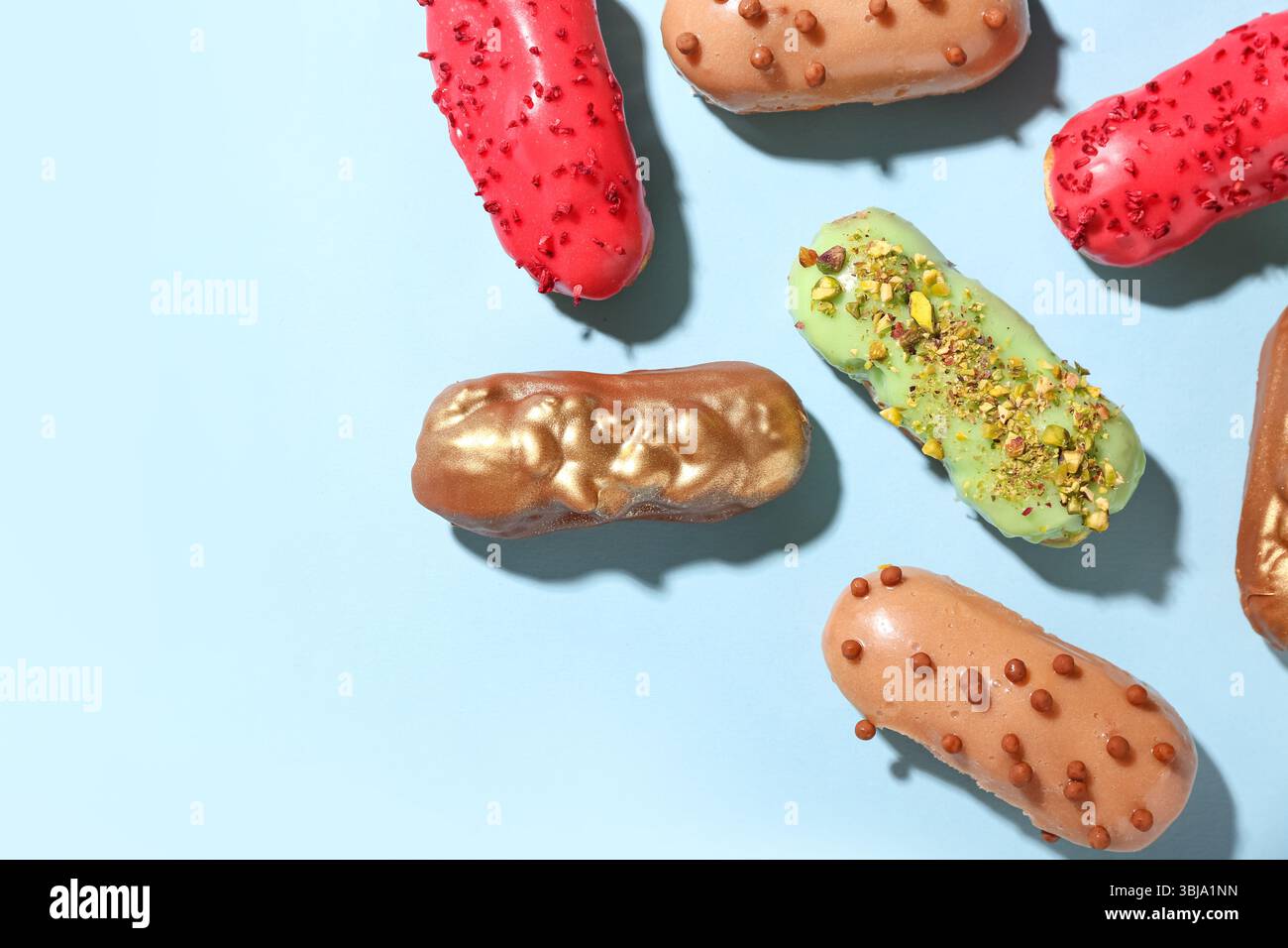 Composition with various glazed eclairs on color background Stock Photo