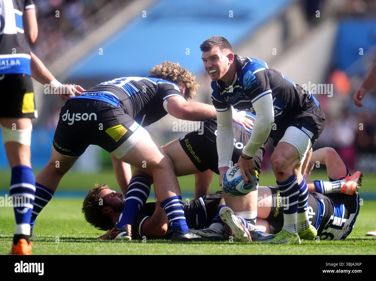 Bath Rugby's Ben Spencer attempts to release the ball from danger ...