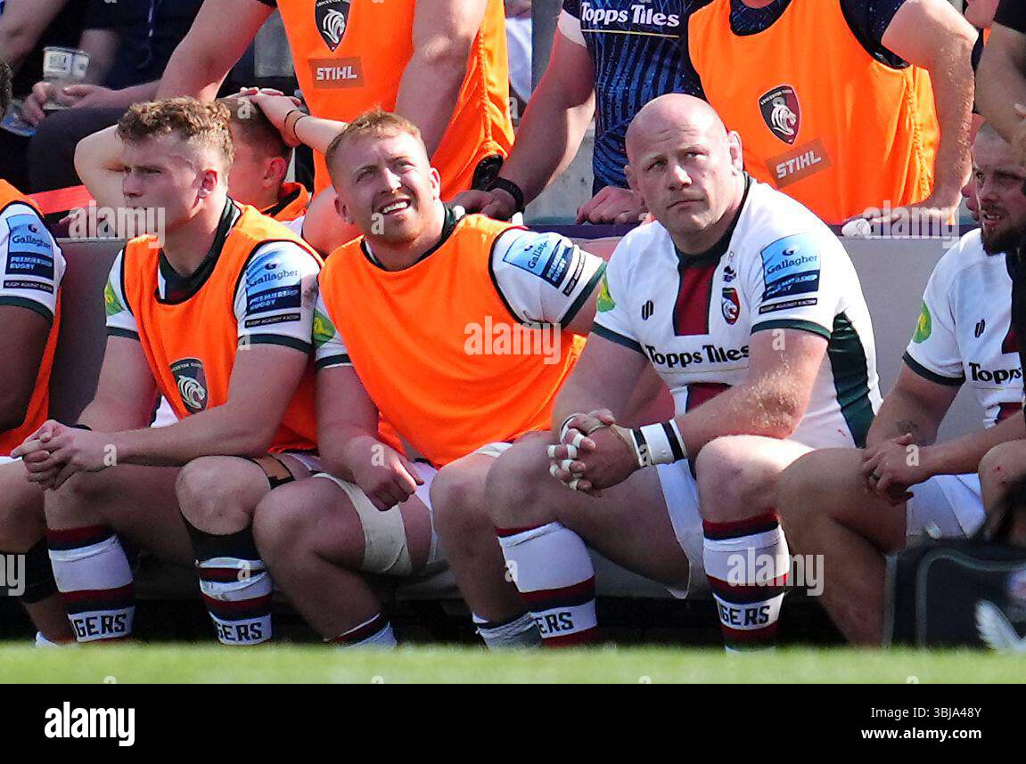 Leicester Tigers' Dan Cole (right) sits on the bench after receiving an ...