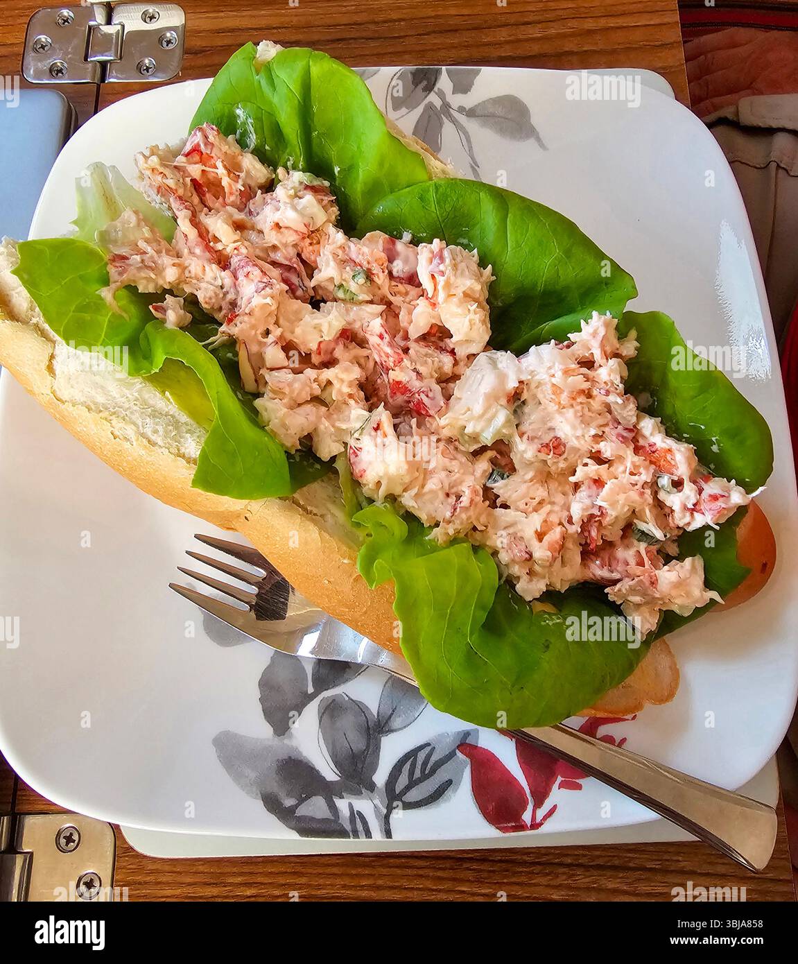 Delicious lobster sandwich on a bun with butter lettuce.  The lobster salad was takeout from a deli in Boca Grande, Florida - Smartphone Captured Stock Image