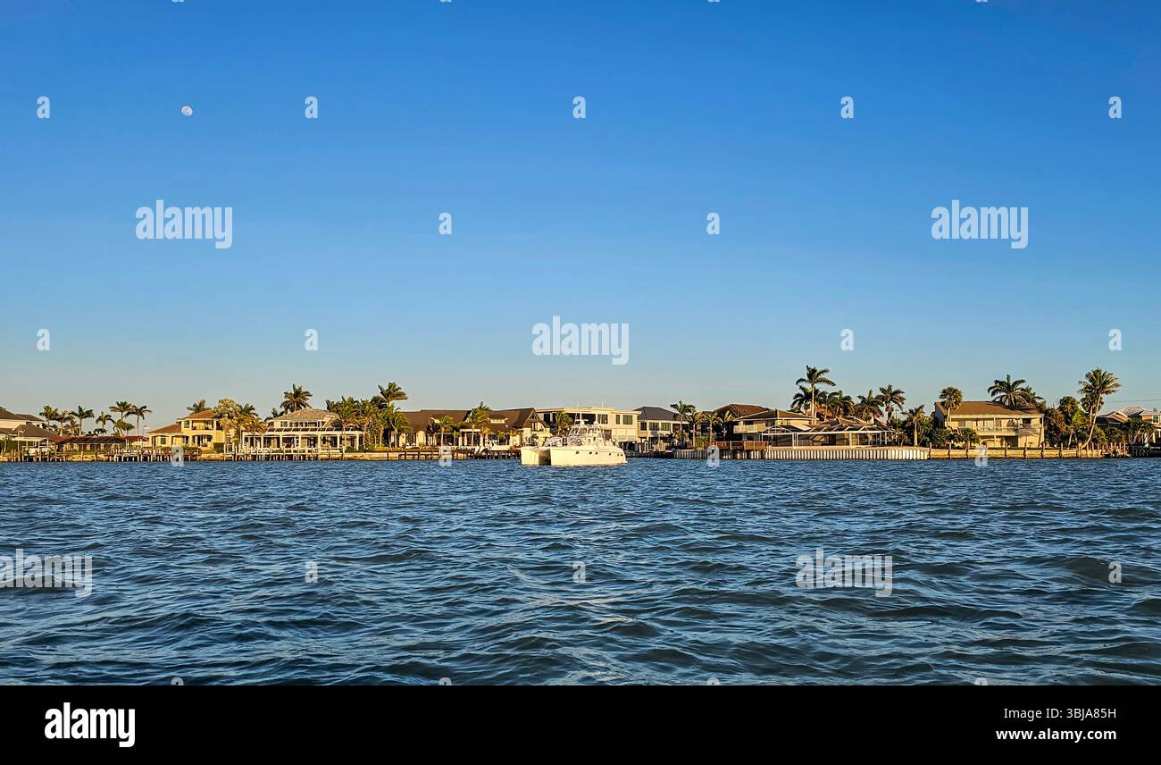 A power catamaran at anchor in the bay, March Island, Florida. A protected bay offers a good, safe anchorage for boats visiting the area. - Smartphone Captured Stock Image