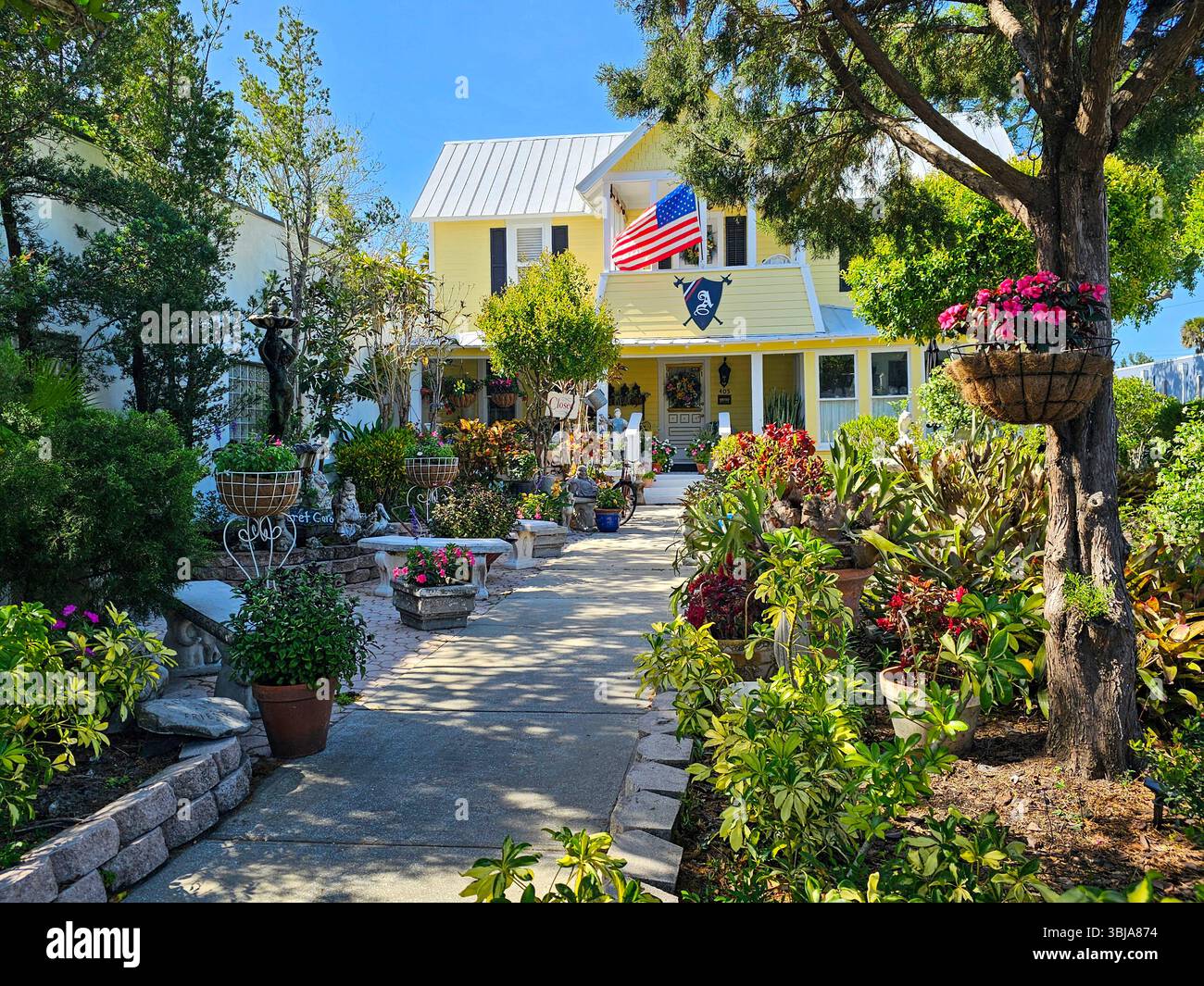 A pretty front garden at an antique store in the Historic Canal Street Downtown, New Smyrna Beach, Florida - Smartphone Captured Stock Image