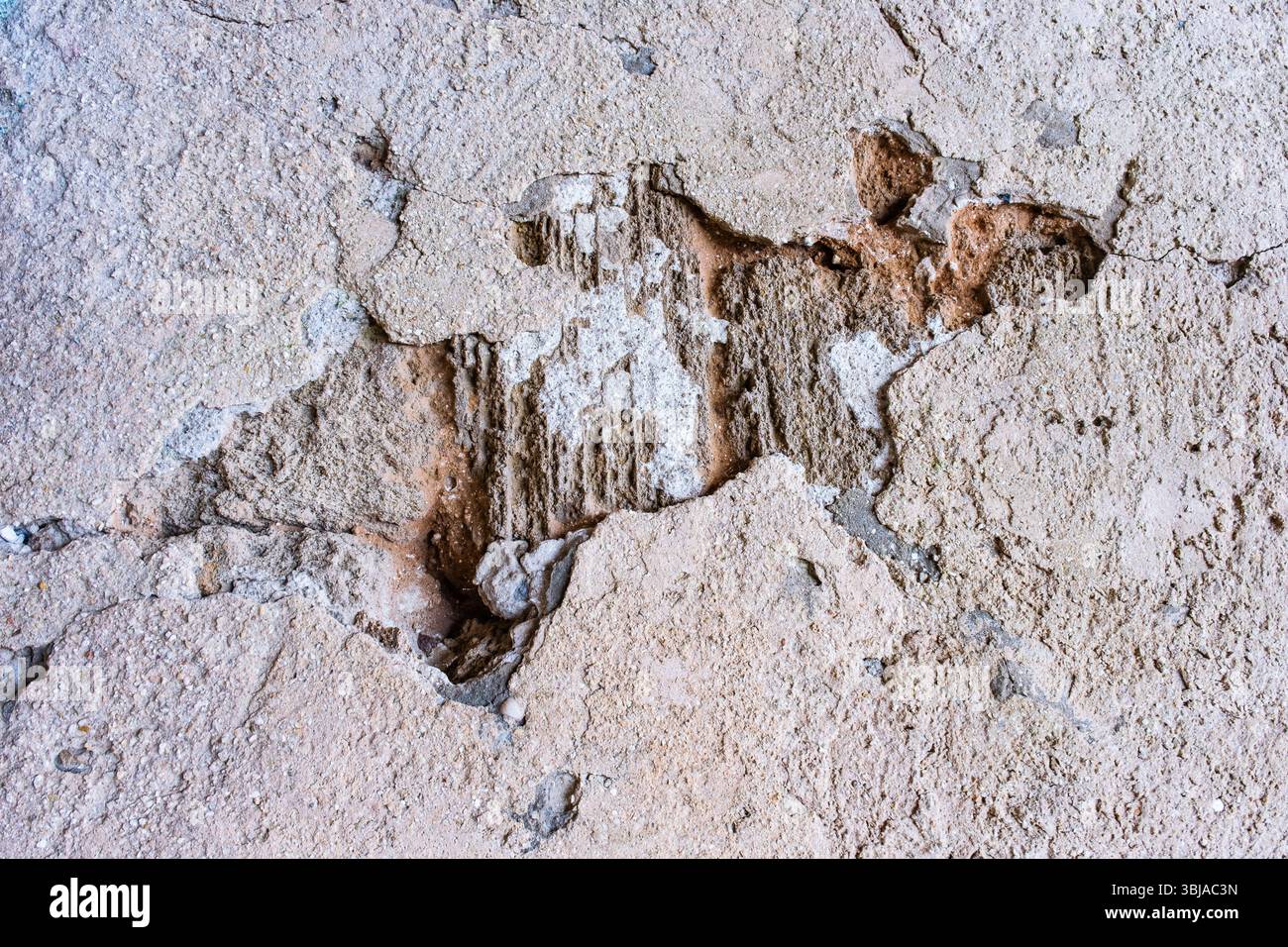 Crumbling plaster on the old wall. Stock Photo