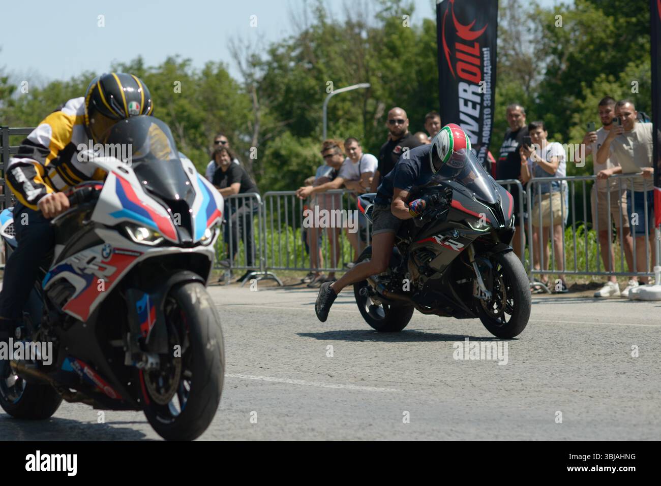 Varna Riders Two motorcyclists on BMW sportbikes launch from the starting line ...