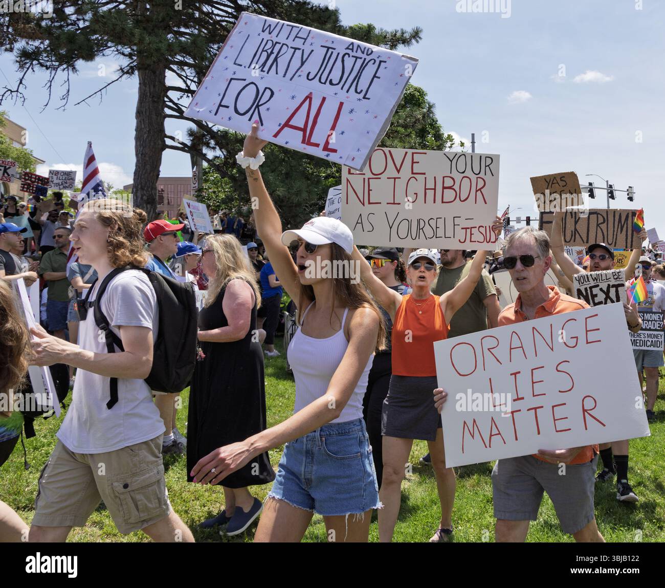 A diverse group of protesters holding signs advocating for justice and ...
