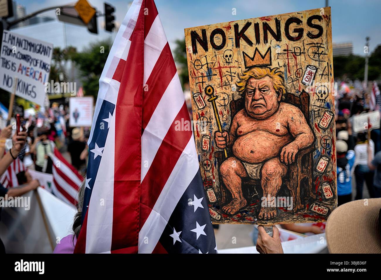 Protesters carry signs and chant slogans during a "No Kings" protest in ...