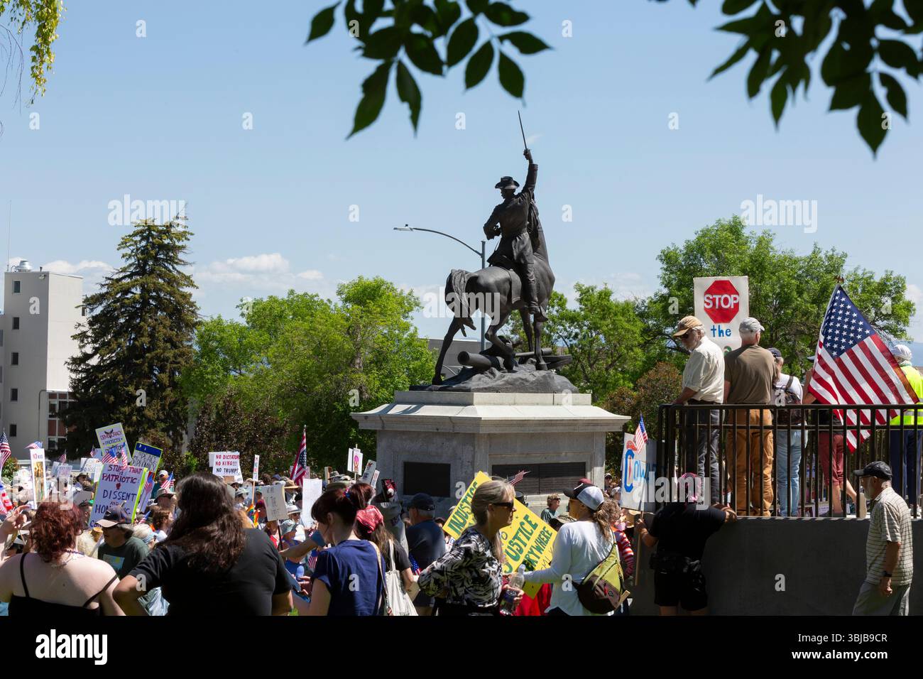 Helena, Montana, USA. 14th June, 2025. Demonstrators gather around the statue of Civil War General Thomas Francis Meagher at the Montana State Capitol for the “No Kings” rally. The national day of action and mass mobilization was organized by the 50501 movement and local organizations in response to perceived authoritarian actions of the Trump administration. Credit: Paul Christian Gordon/Alamy Live News Stock Photo