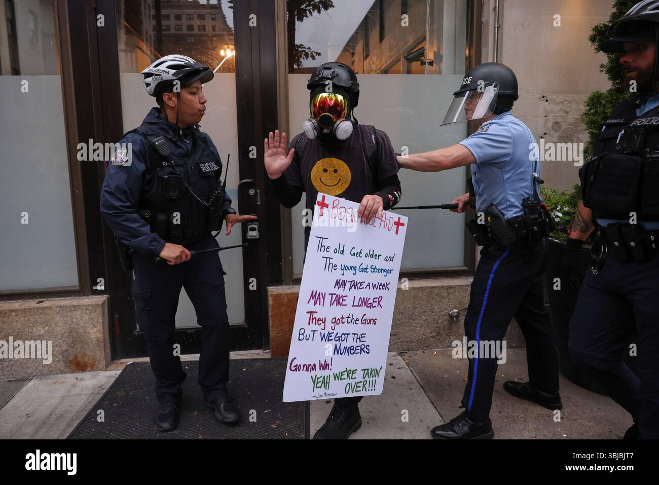 Police officers confront a protestor, Saturday, June 14, 2025, in ...