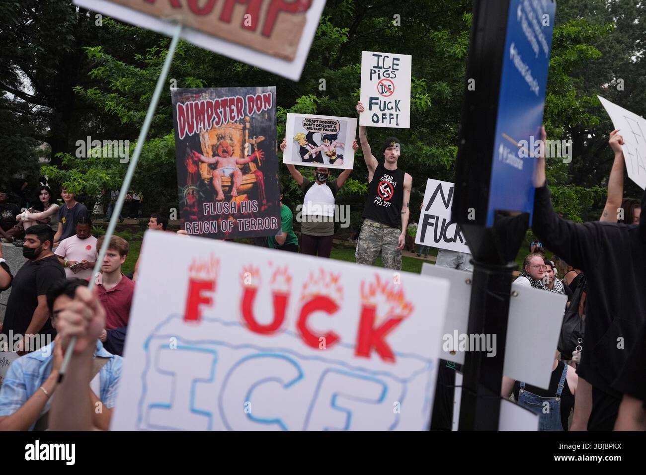 EDS NOTE: OBSCENITY - Demonstrators hold up signs during a protest ...