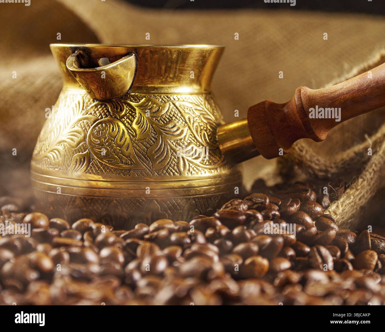 Golden cezve with freshly roasted coffee Stock Photo