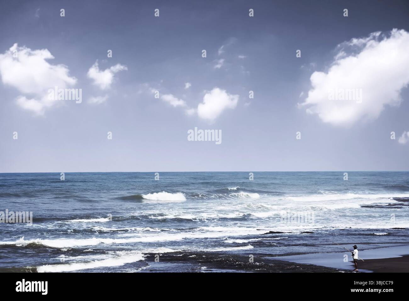 Beautiful tropical beach scene with fisherman fishing Stock Photo